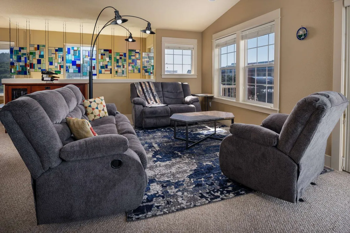 A comfortable sitting area with stylish sofa seating, colorful wall art, and a coffee table—perfect for relaxed conversation or quiet moments with a book.